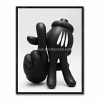Tableau Kaws noir avec personnage courbé cachant son visage derrière ses mains et gouttes blanches graphiques.