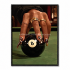 Main féminine avec bijoux et manucure posée sur une boule de billard noire numéro 8.
